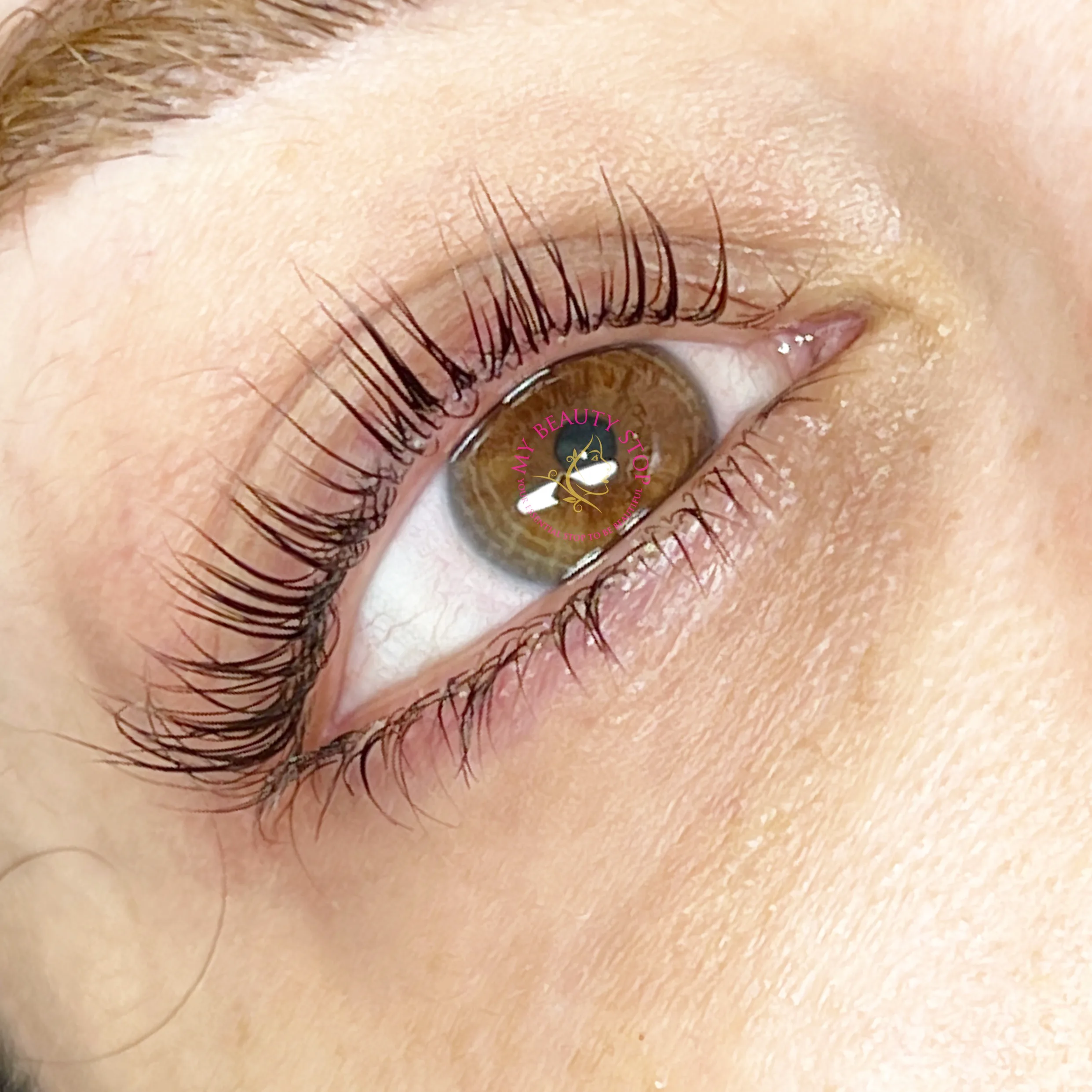 Lash lift result — green-hazel eye macro, lifted natural lashes set in a wide-open position